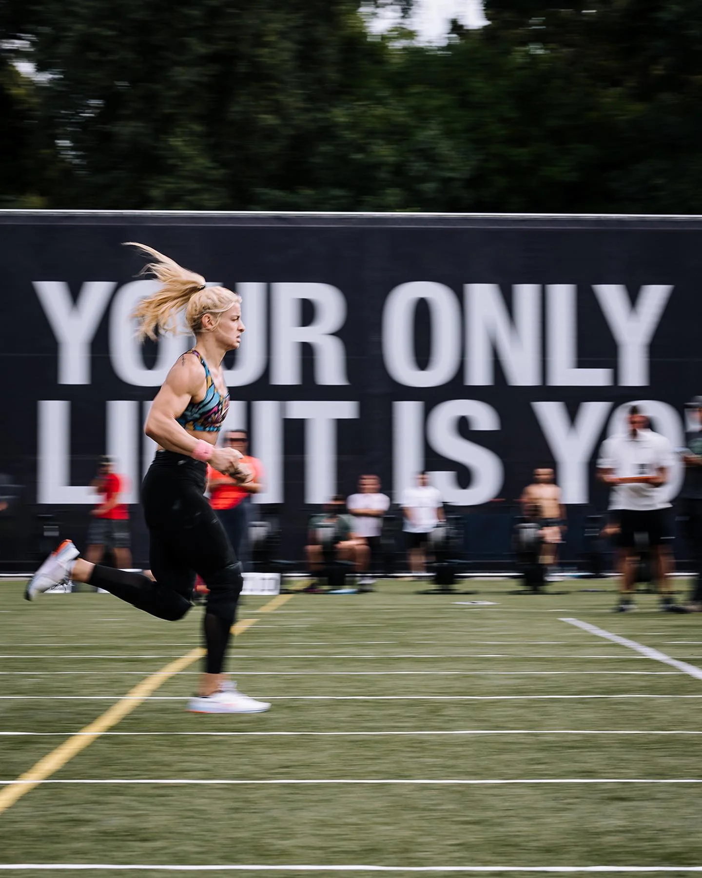 Female athlete running across the turf at Nike Metcon FortFight in Belgrade